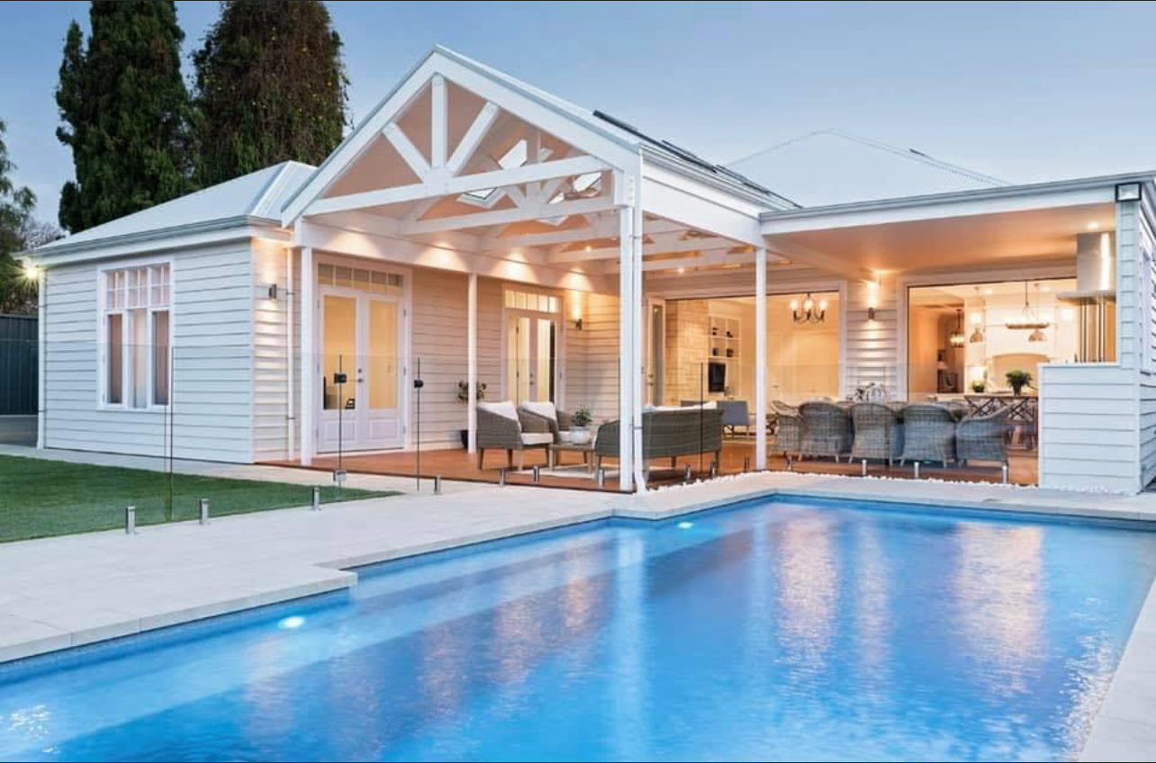 Pool in front of a white house