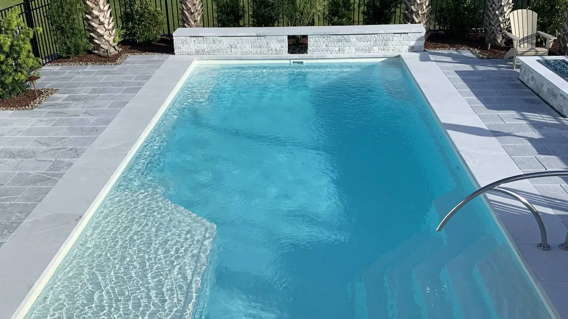 a newly installed fiberglass pool and landscaped patio area