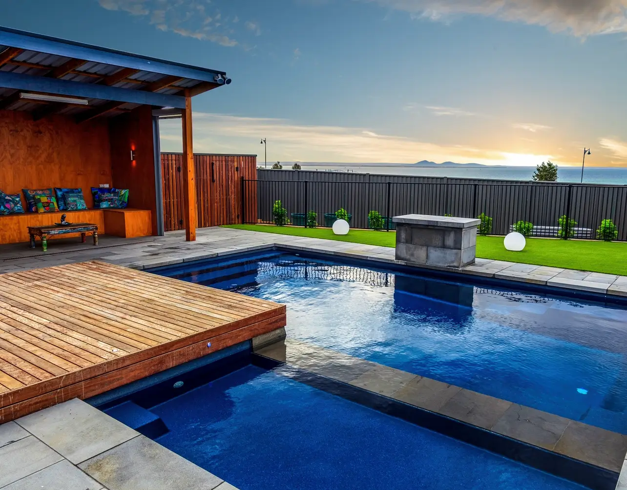 pool spa combo with unique deck and outdoor seating area