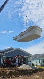 Fiberglass Pool Builder Myrtle Beach SC lowering pool shell into the ground